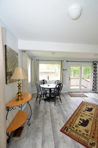 a living room with a table and chairs and a dining room at Black Bear Cabin - Fire Pit, Grill, View, Pet Friendly, Fireplace, King Bed, Wifi, Game Room in Morton Grove