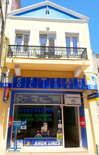 a store front of a building with blue signs on it at SITIA CITY CENTER luxury apartment in Sitia
