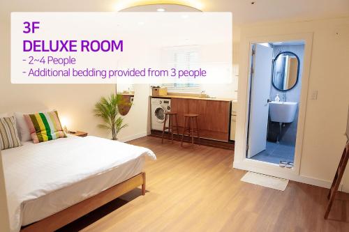 a bedroom with a bed and a bathroom with a sink at Hostel Mihojae Busan in Busan