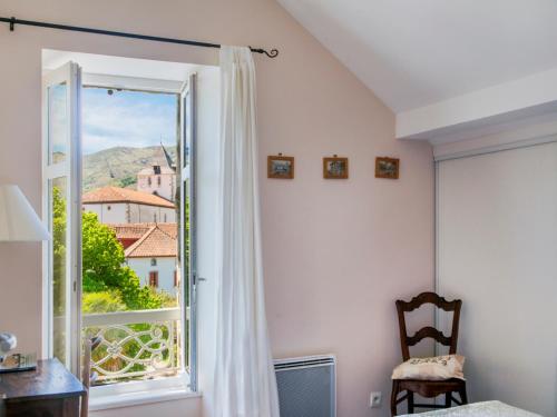 a room with a window and a chair with a view at Chalet Elisa Chambre d'Hôtes in Sare
