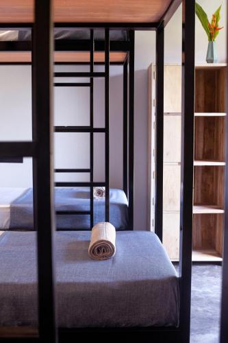 a room with two bunk beds with a hat on top at The Well in Ahangama