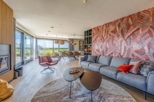 a living room with a couch and a table at Natuurvilla 16 Weegeswaal in De Waal