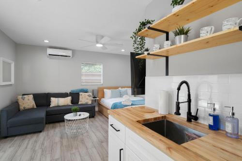 uma cozinha e sala de estar com um sofá e um lavatório em Cozy Studio Walking Dis From Rj Stadium em Tampa