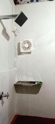 a white wall with a toilet in a room at Verdant Vagamon Farm House in Vagamon