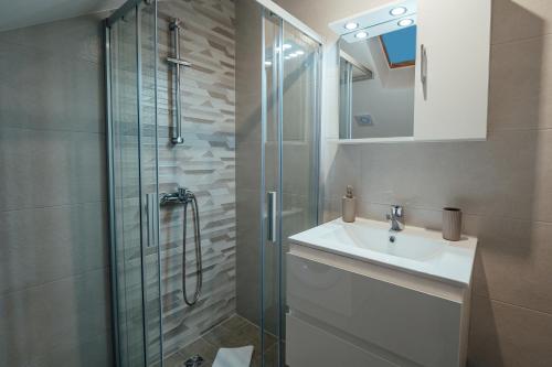 a bathroom with a sink and a glass shower at Apartman Josipa in Zagvozd