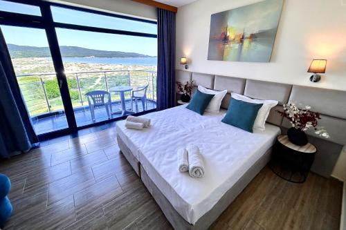 sypialnia z łóżkiem i widokiem na ocean w obiekcie Hotel Penelope w Primorsku
