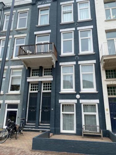 a blue building with a balcony on the side of it at Sol y Mar in Vlissingen