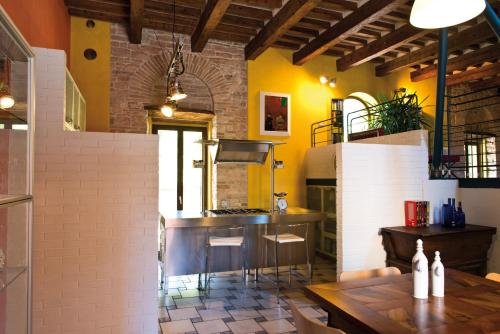 a kitchen with a counter and a table in a room at Spazio seicentesco in Fossombrone
