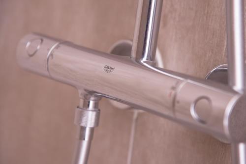 a close up of a metal towel rack in a bathroom at Chic Appart - Sauna privatif in Tourcoing