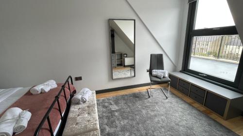a bedroom with a bed and a mirror at Chapel row 4 in Wirksworth