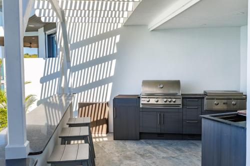 a kitchen with a stove and a grill at Tamarind Hills Resort & Villas in Johnsons Point