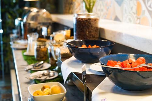 a buffet with bowls of fruit on a table at Stannum Boutique Hotel & Spa in La Paz