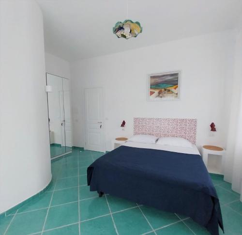 a bedroom with a bed and green tile floors at Villa del Sole in Capri