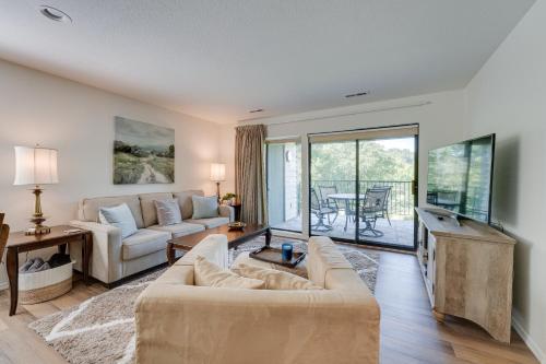 a living room with a couch and a tv at Branson Condo Near 76 Strip and Silver Dollar City in Branson