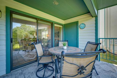 a porch with a table and chairs on a house at Branson Condo Near 76 Strip and Silver Dollar City in Branson