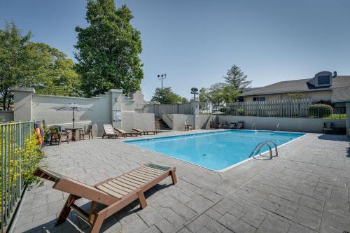 a swimming pool with a bench and a table and chairs at Branson Condo Near 76 Strip and Silver Dollar City in Branson