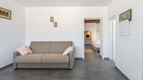a living room with a couch and a bedroom at Milos Bay View in Zefiría