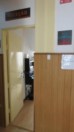 an open door in an office with a sign on the wall at Alojamento Local Duarte's in Coimbra
