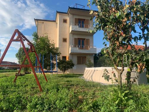 una casa con un parco giochi di fronte di Apollonia Apartment a Fier