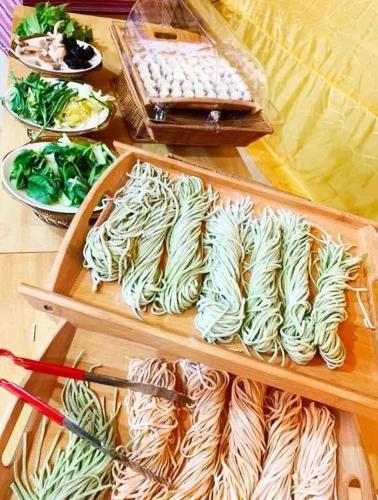a table topped with plates of food and bowls of vegetables at KaoShan Tent Zhangye in Zhangye