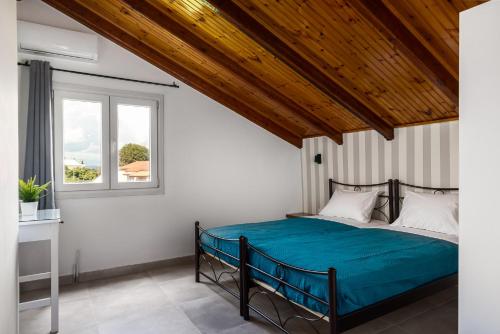 a bedroom with a bed and a window at Attico Verde in Kastanéa