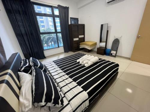 a bedroom with a bed with black and white stripes at Barget and Lovely House at Atlantis in Melaka