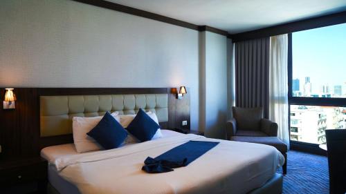 Postel nebo postele na pokoji v ubytování MENA Tyche Hotel Amman