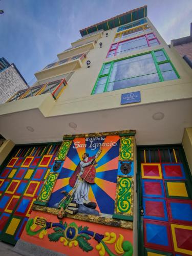 a building with a mural on the side of it at Casa García Rent Home in Guatapé