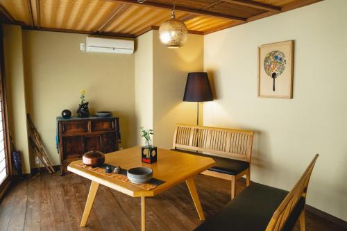 a living room with a wooden table and a chair at Kyo no Yado Sangen Ninenzaka in Kyoto