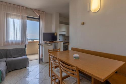 a living room with a table and a couch at Hotel Quisisana in Vada