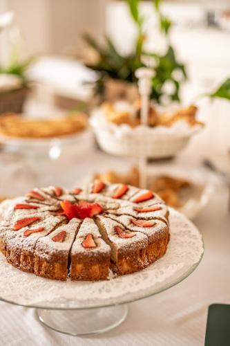 a cake sitting on a plate on a table at Villa Clementina - Prosecco Country Hotel in San Pietro di Feletto