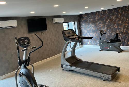 a gym with two exercise bikes and a television at La Quinta by Wyndham Nashville Airport in Nashville