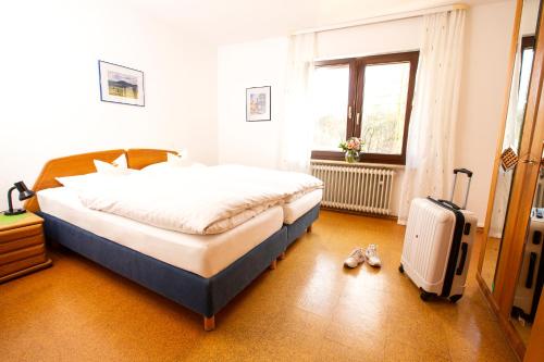 a bedroom with a bed and a suitcase in it at Ferienwohnung in Lippstadt