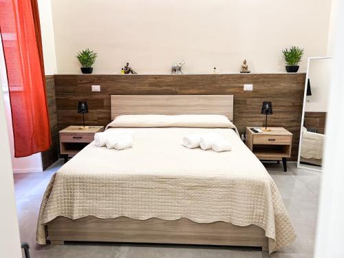 a bedroom with a bed with two towels on it at Al 115 Rooms in Cagliari