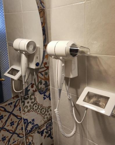 a hair dryer in a bathroom with a mirror at Casa Mirabilis 44 in Ostuni