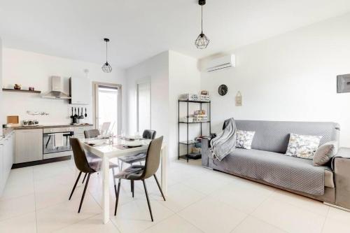 a living room with a table and a couch at Casa SarTuga in SantʼAntìoco