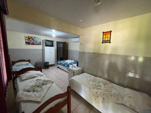 En eller flere senge i et værelse på Pousada do Gordo