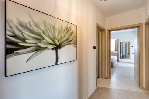 a large painting of a flower on a wall at Pool Apartment-Hosted by Sweetstay in Is-Swieqi