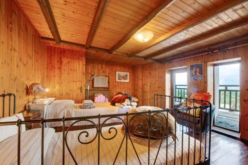 a bedroom with a bed in a room with wooden walls at Casa Jonathan in Saint Vincent