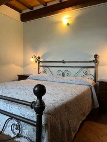 a bedroom with a bed with a white bedspread at Agriturismo Le Sorgenti in Norcia