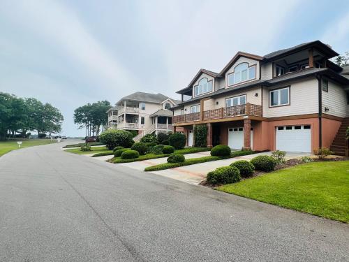 a large house on a street with a driveway at Fairway to Heaven home in Supply