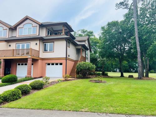 a house with a green lawn in front of it at Fairway to Heaven home in Supply
