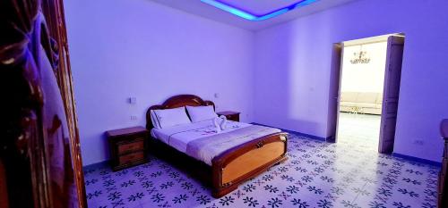 a bedroom with a bed in a room with purple walls at Torrione Maison in Ischia