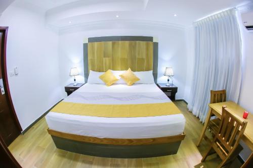 Un ou plusieurs lits dans un hébergement de l'établissement Hotel Vicentina