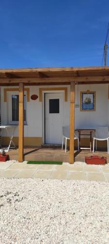 a pavilion with a table and chairs on a patio at Apartamentos na Quinta Altavista do Carvalhal in Zambujeira do Mar
