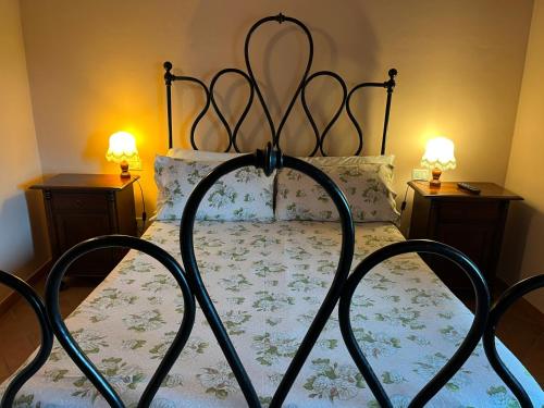 a bedroom with a bed with a wrought iron headboard at Agriturismo Le Sorgenti in Norcia