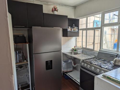 a kitchen with a stainless steel refrigerator and a sink at Barcena in Durango