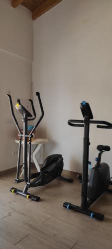 a room with three exercise bikes and a table at Apartamentos na Quinta Altavista do Carvalhal in Zambujeira do Mar