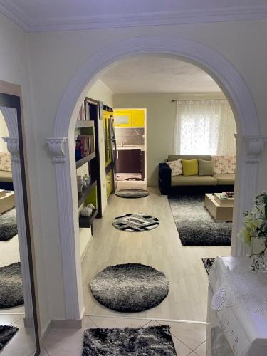 an archway in a living room with a couch at Lula Guesthouse in Gjirokastër