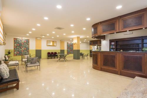 a large lobby with chairs and tables in a building at Hotel Orizzonte in Letojanni